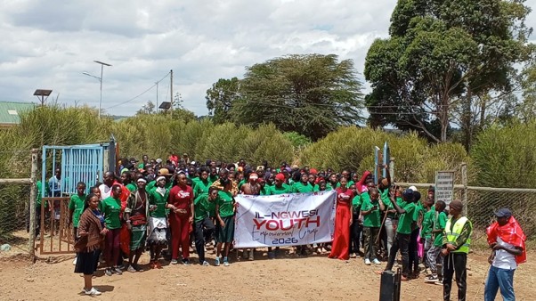 Camp attendees gathering at the gates of the school where the camp was held
